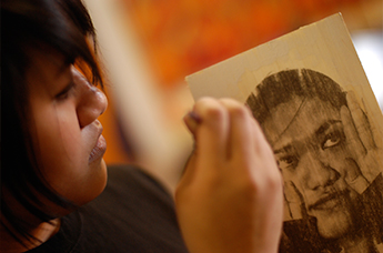 Young artist working on a self-portrait. Courtesy RAW Art Works.